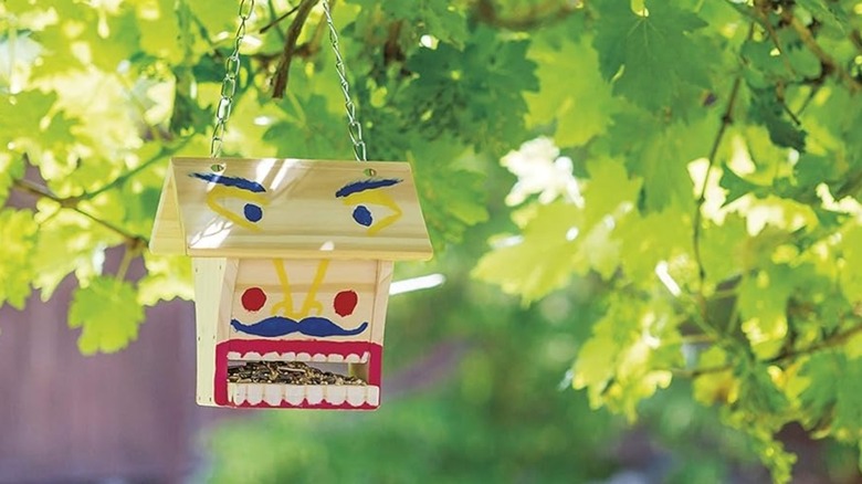 Painted Beetle & Bee Build A Bird Buffet hanging from tree