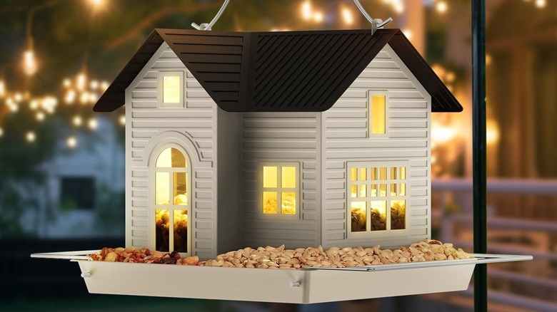 MrCrafts Solar Hanging Metal Bird House Feeder illuminated at night