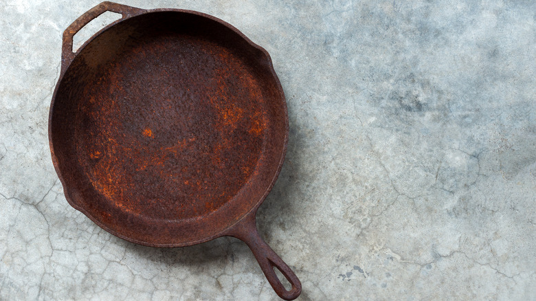 Rusted cast iron pan on countertop 