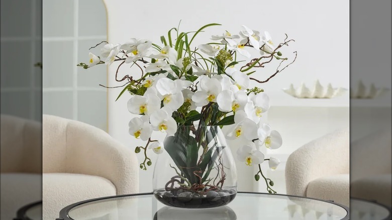Allstate Living Faux Phalaenopsis Orchid Arrangement on coffee table