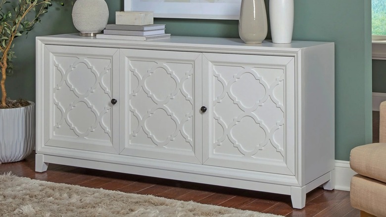 Universal Broadmoore Wynne Accent Console in entryway stacked with vases and books