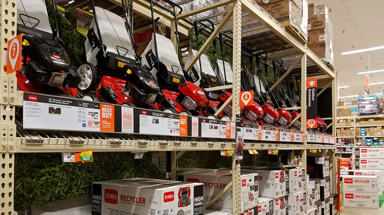 Lawn mowers are on display at a Home Depot