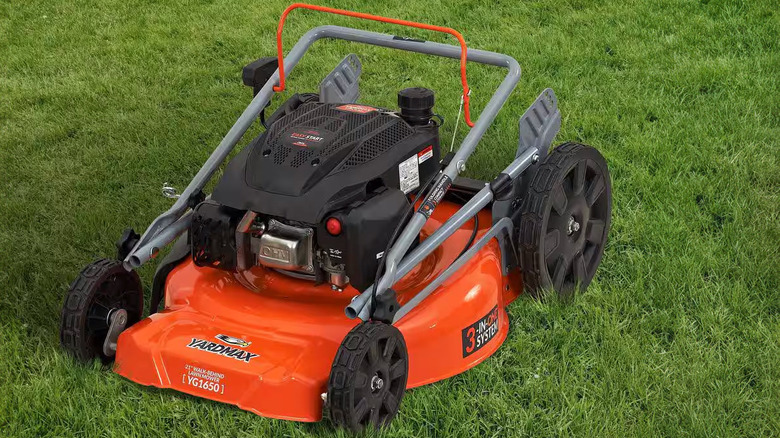 A Yardmax YG1650 sits on a patch of grass while folded