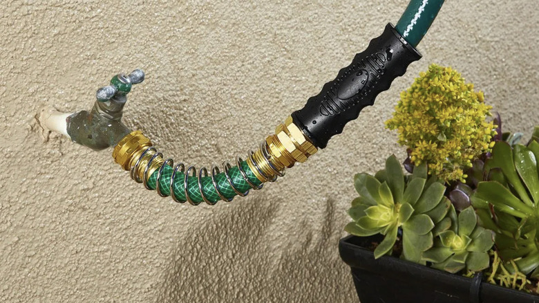 A faucet with Greenwood's coiled spring faucet connector attached to the hose