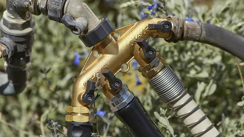 One Stop Gardens' 4-in-1 faucet expander hooked up to a faucet with four hoses