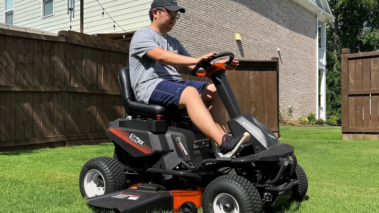 Man riding a Yardforce battery-powered riding lawnmower