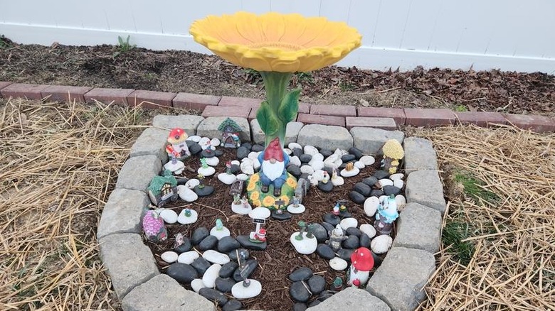 Style Selections' 20-inch Yellow/Green Resin Complete Birdbath in a fairy garden bed
