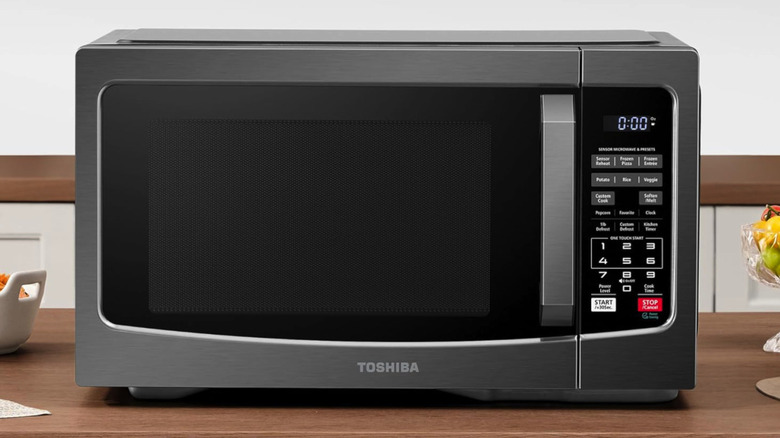 Toshiba EM131A5C microwave on a wood counter