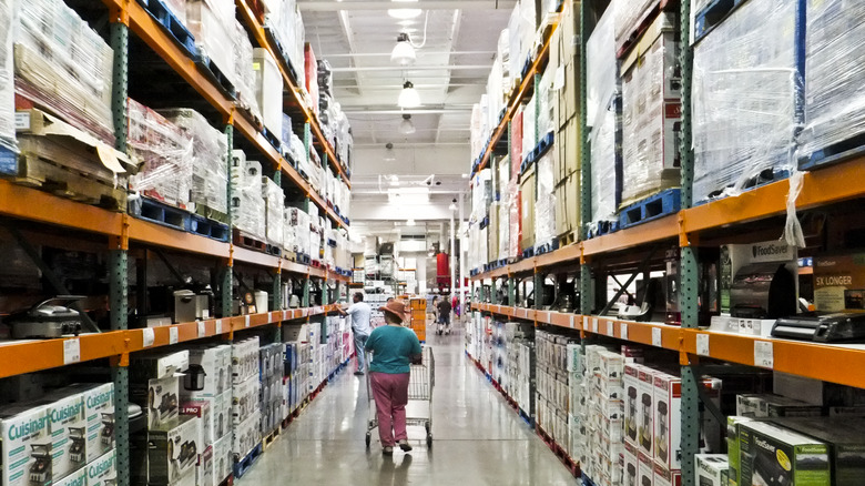 Woman walking down a kitchen appliance aisle at Costco