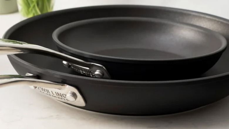 A large, clean frying pan with a smaller frying pan inside it