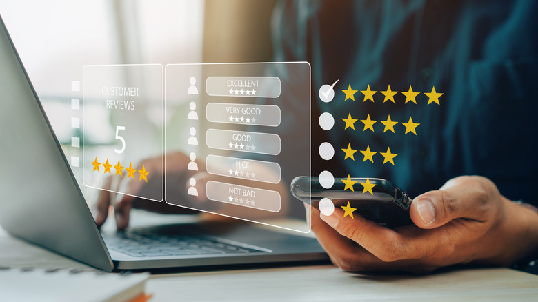 Person at latptop holding a phone with icons in front of image of 1 to 5 star ratings