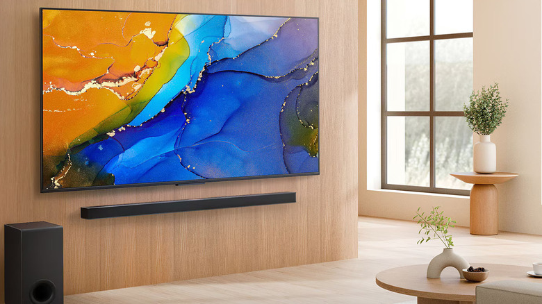 LG's QNED84B Mini LED 4K Smart TV on a contemporary living room wall