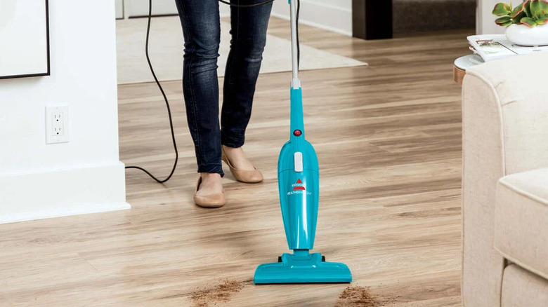 woman vacuuming with Bissell Featherweight
