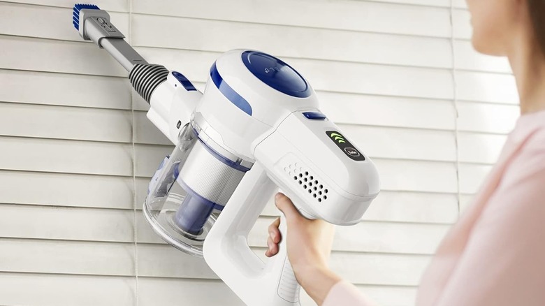 white and blue handheld vacuum
