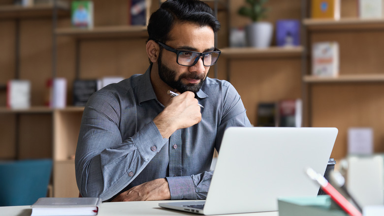 man looking at laptop