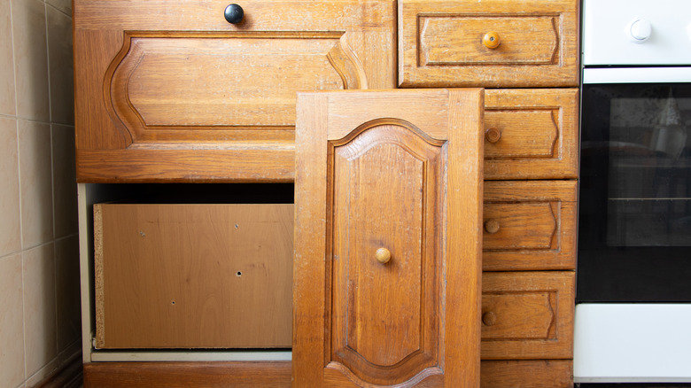 Antique-style base kitchen cabinets with a door removed