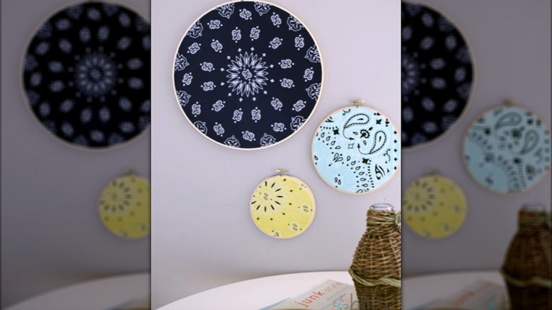 Black, yellow, and white bandanas inside embroidery hoops and trimming the edges makes easy wall art