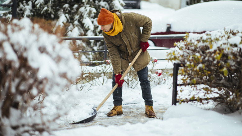 Man shoveling snow during heavy winter weather