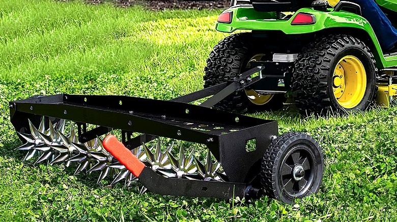Suchtale 40-Inch Tow Behind Spike Aerator attached to a lawn tractor