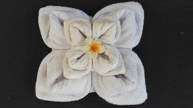 Towel flower decorated with real flower