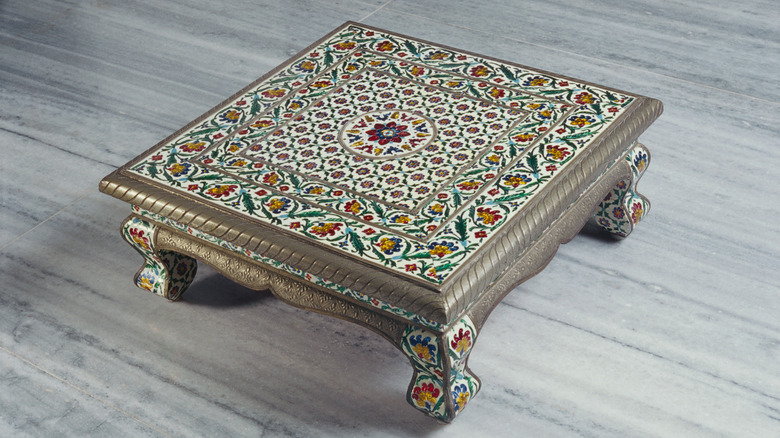 A low profile decorated Indian prayer table.