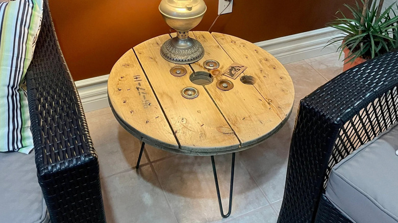 The top of a wire spool varnished and repurposed as a coffee table.