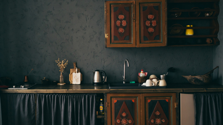 A dark kitchen with traditional details.