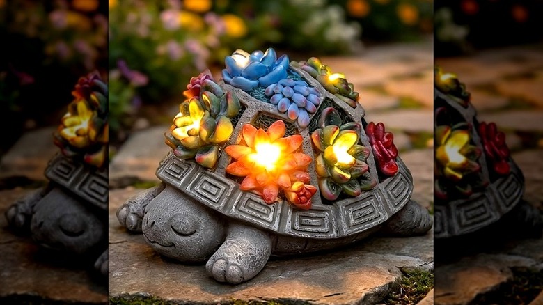 A faux stone turtle figurine with succulent solar-powered lights on its shell