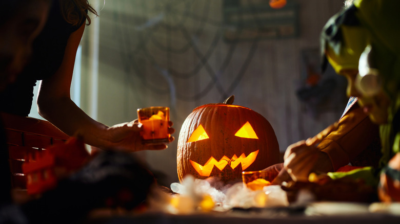 Kids decorating a table with Halloween decor