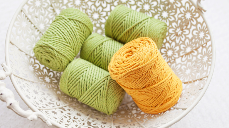 Green and yellow colored rope in a floral bowl