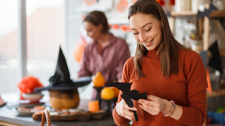 woman making Halloween decorations