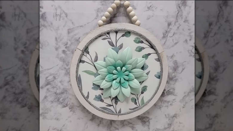 Wooden sign with flower in middle