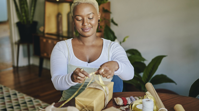 woman wrapping present 