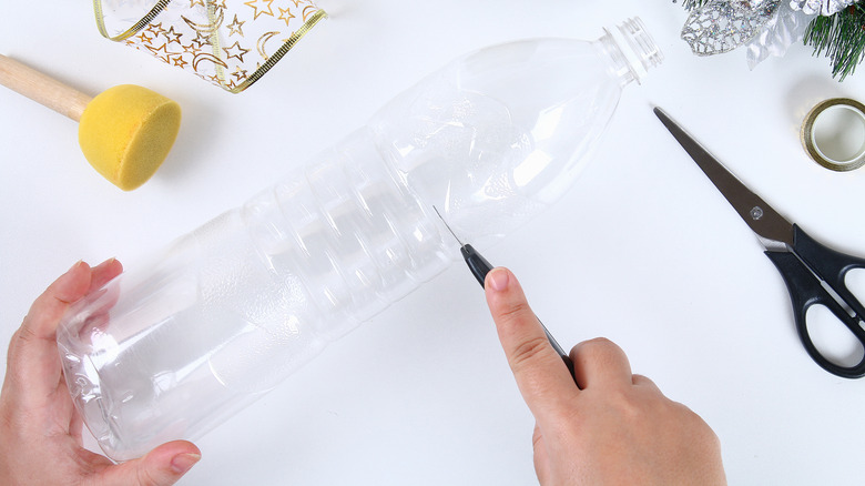 cutting into plastic bottle 