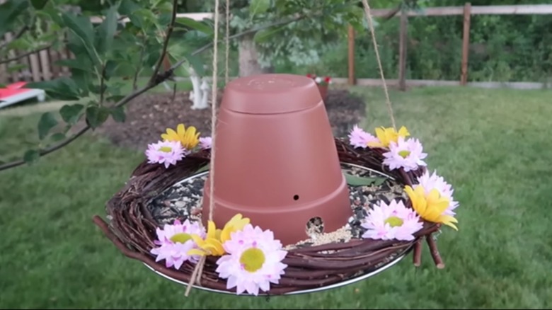 DIY bird feeder hanging from tree branch