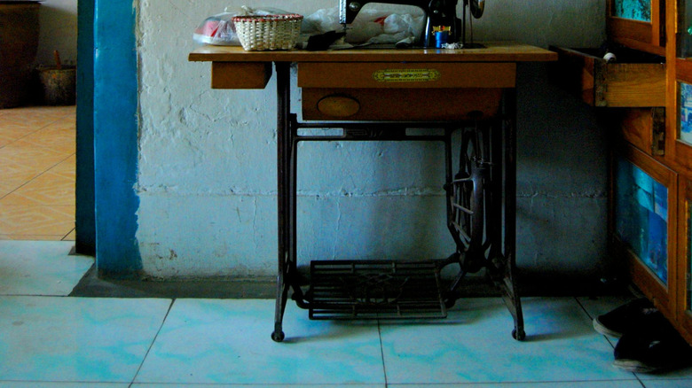 An old sewing cabinet against a wall