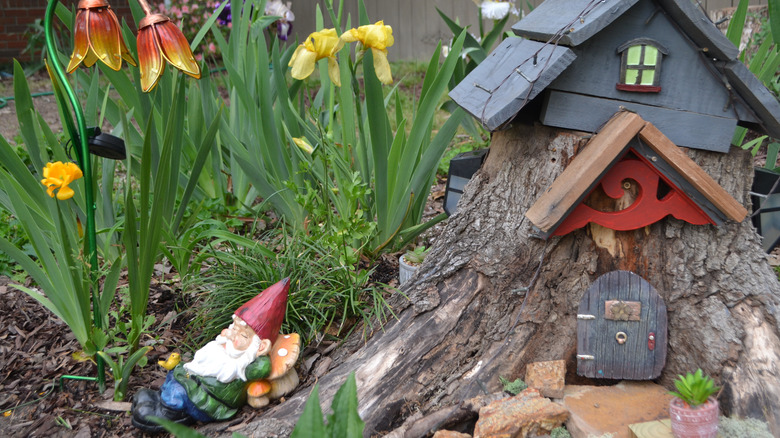 A tree stump decorated as a gnome home