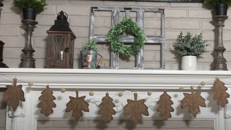 A brown bag leaf garland hanging on the mantel