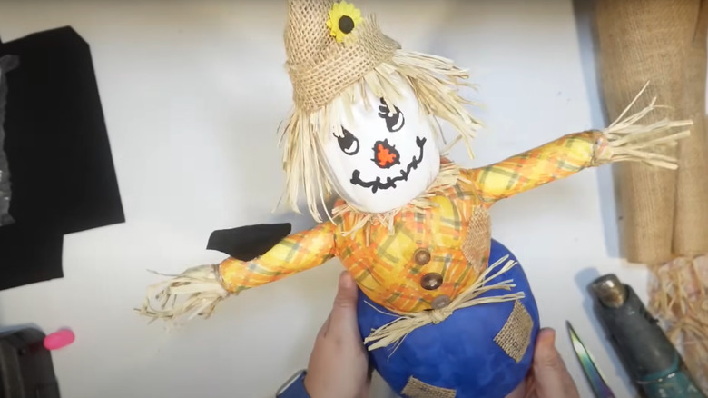 homemade scarecrow on crafting desk