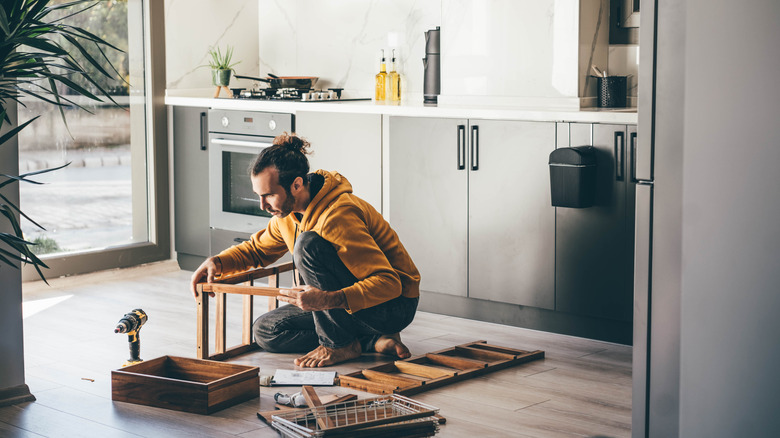Someone building furniture