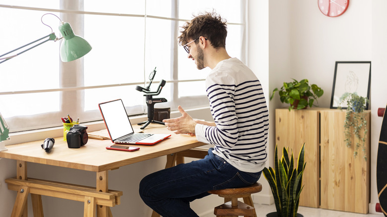 Man sitting at desk with laptop