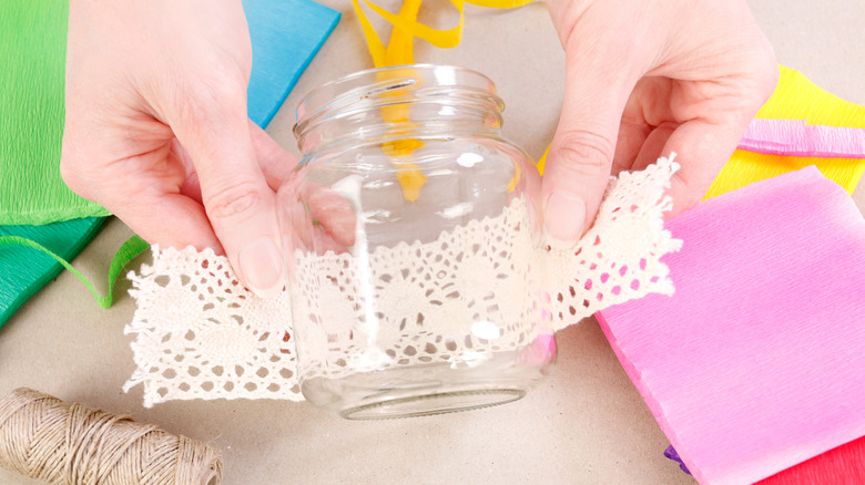 Person using a glass jar for a craft