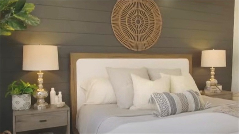 Shiplap accent wall above the bed