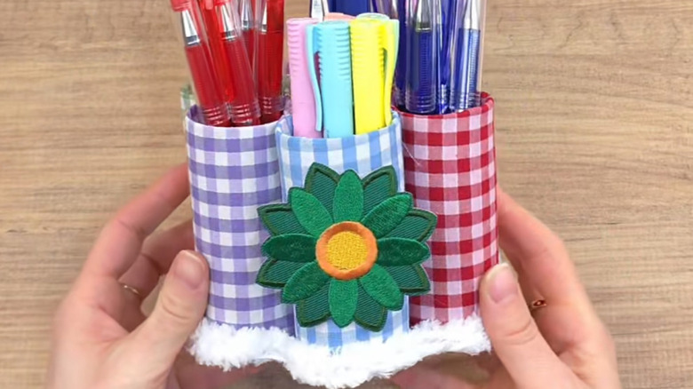 A pen holder storage DIY made with fabric and toilet paper rolls