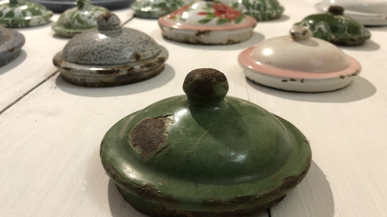 Worn vintage container lids sitting on a table