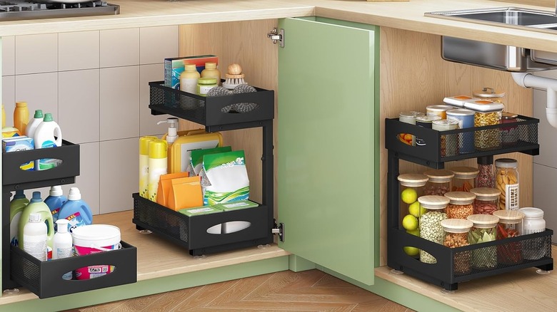 Under sink cabinet organizers holding cleaning supplies