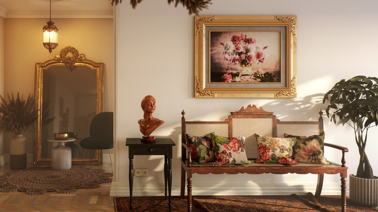 Elegant entryway with rattan bench and gold frame painting
