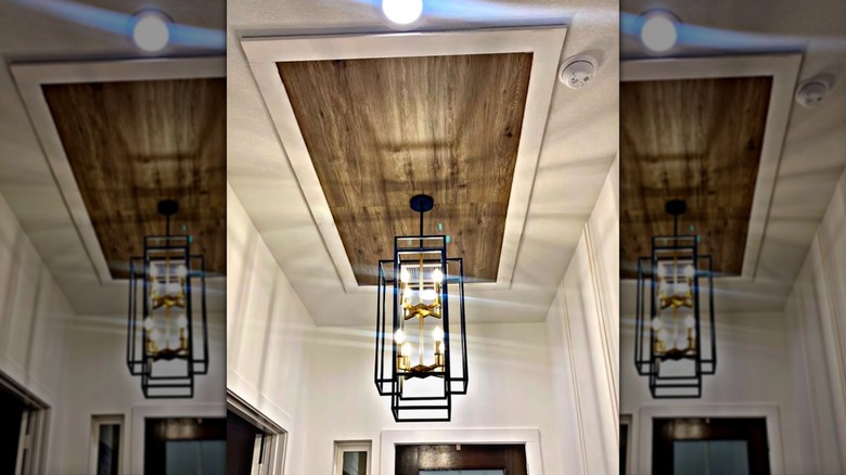 Wood plank ceiling accent in entryway.