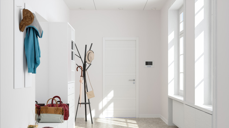 Sparsely decorated, all white entryway.