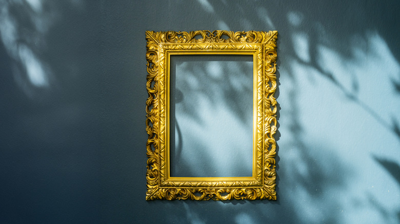 Vintage picture frame on the wall in the sun